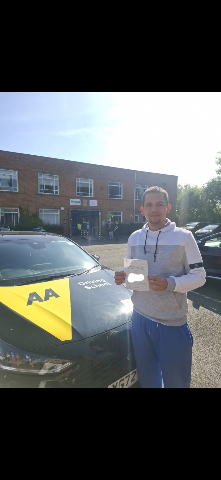 Learner holding a driving test pass certificate